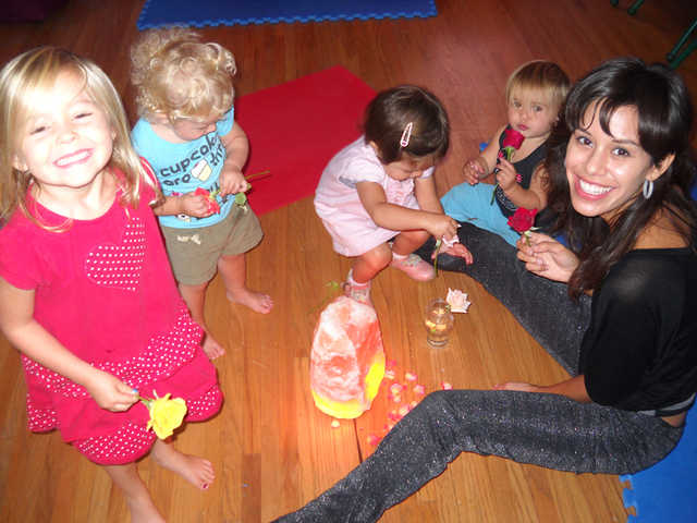 Happy kids playing with smiling woman